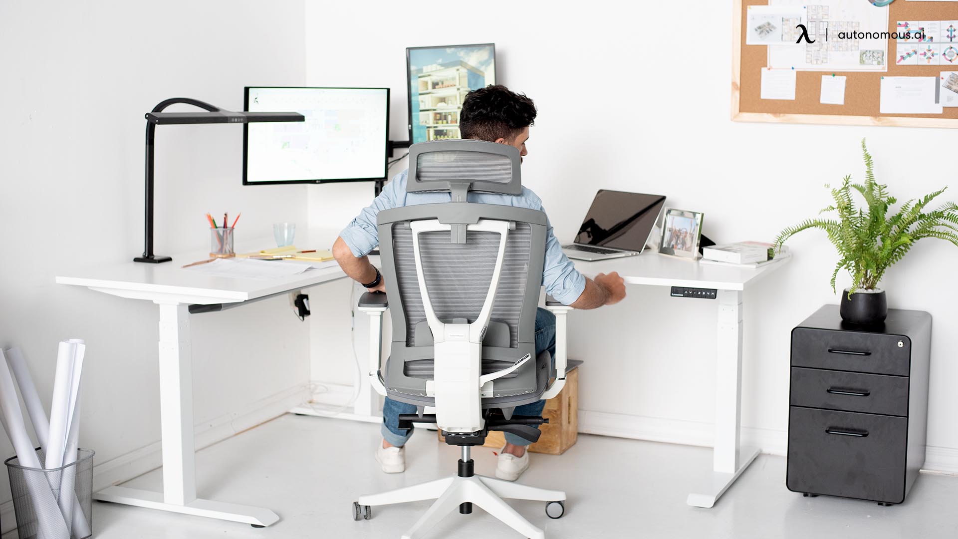 Adjustable chair beside hardwood desk with dual monitors